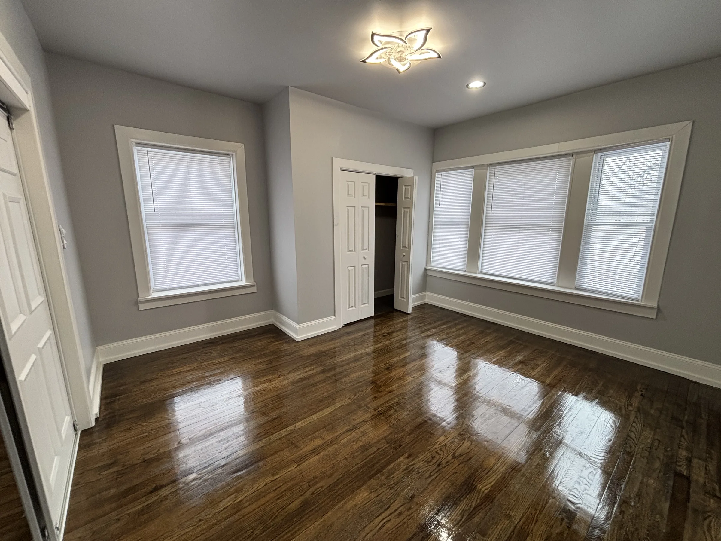 Finished living room with bay windows