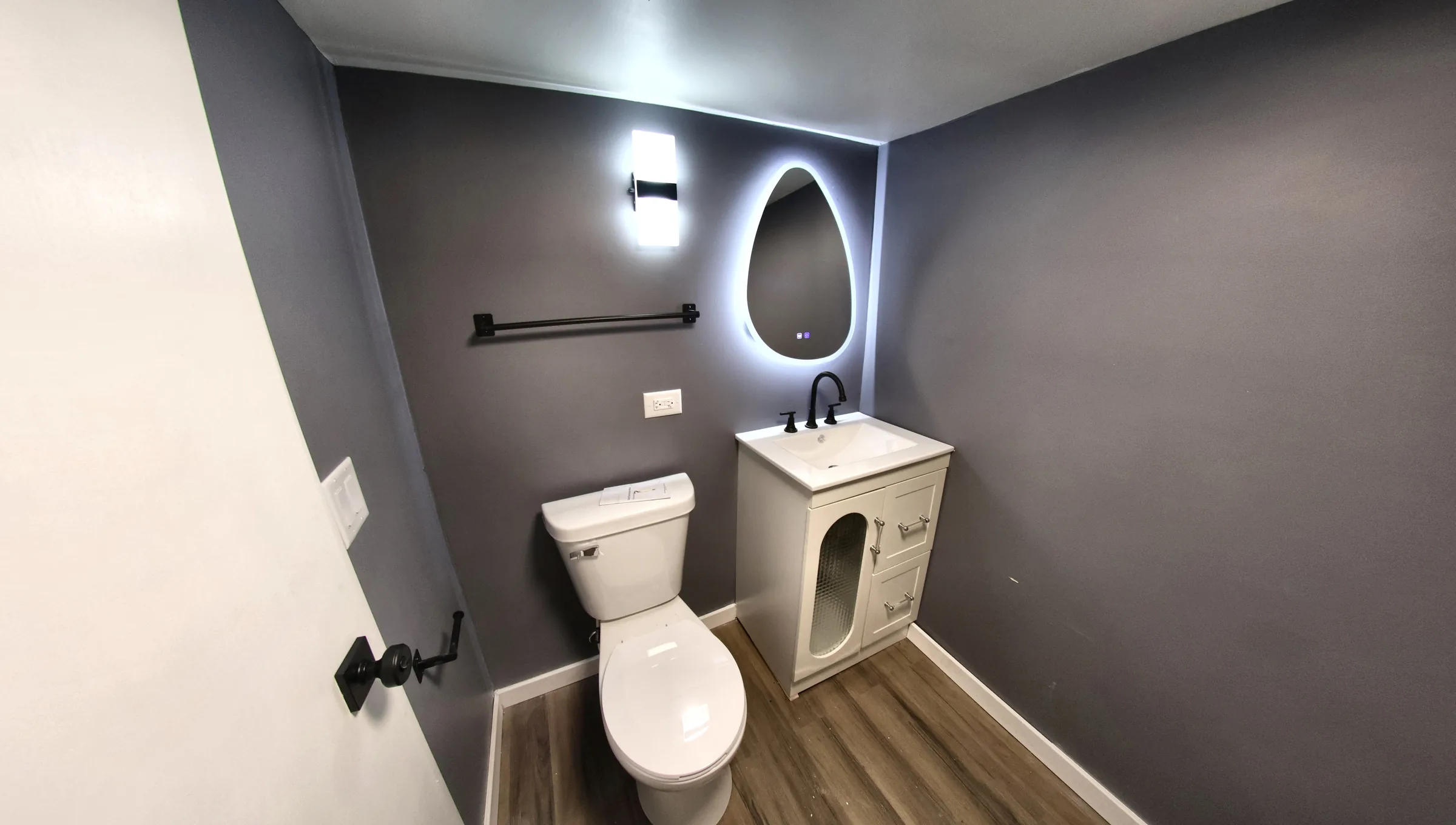 Finished bathroom with a new vanity, fixtures, and lighting