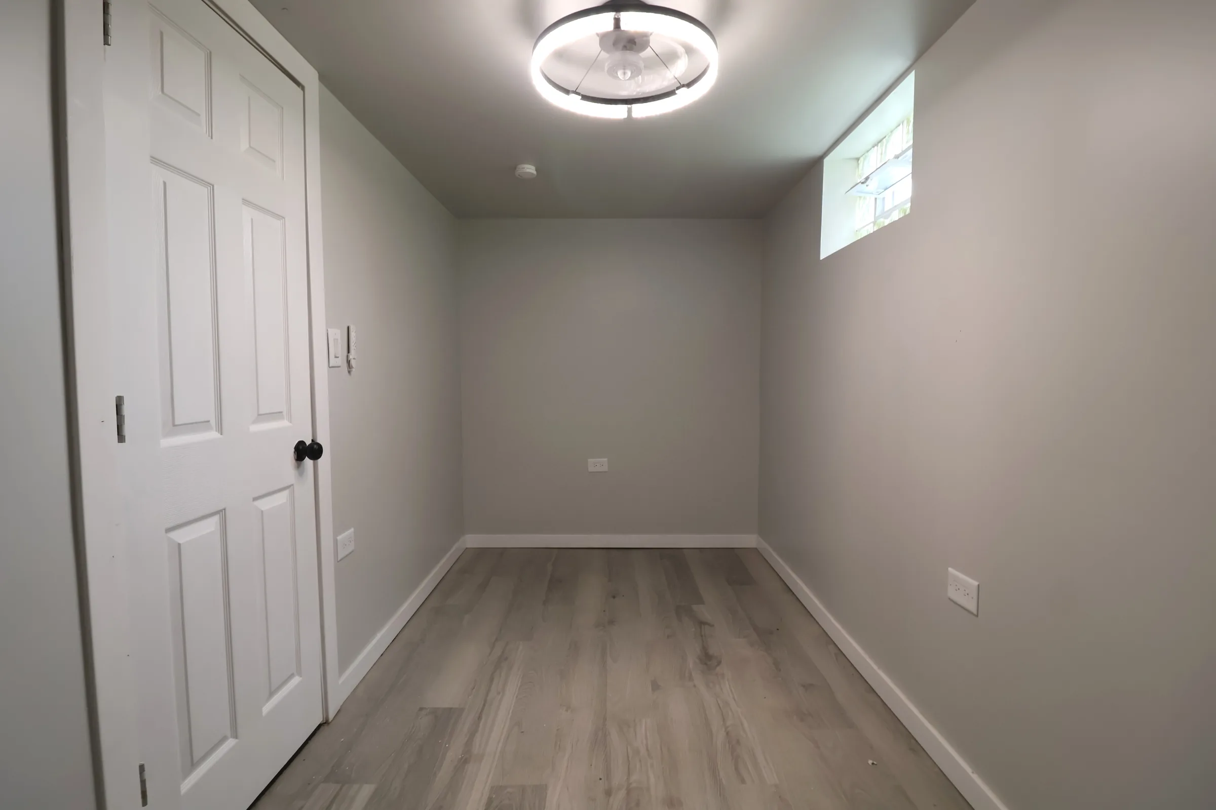 Finished room with light vinyl flooring and trim